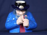 une figurine représentant un homme portant un haut-de-forme et une cravate