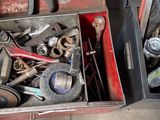 a lot of tools in a tool box on the floor