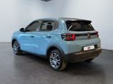 the rear end of a blue car parked in a garage