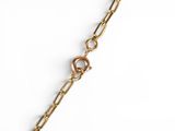 a close up of a gold chain bracelet on a white background