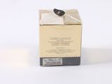 a small box with a label on it on a white surface