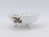 a close up of a white bowl with berries on it