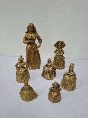 brass figurines of a woman with a child and other figurines
