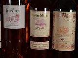 several bottles of wine are lined up on a shelf