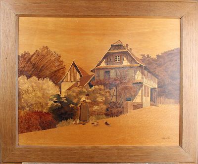 une photo d'un tableau représentant une maison accrochée à un mur