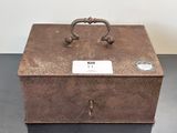 a metal box with a handle on it on a table