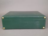 vintage green leather suitcase with brass studs and handles