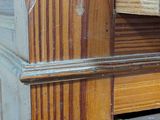 a close up of a wooden dresser with drawers