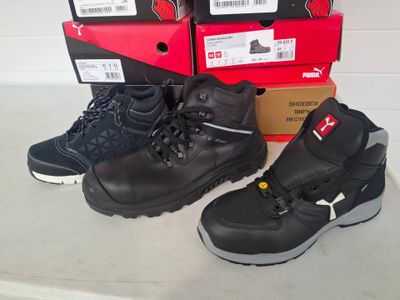 two pairs of black work boots next to each other