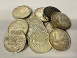 a pile of coins sitting on a white surface