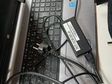 a laptop with a keyboard and a charger on top of it