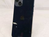 a black iphone sitting on a stand on a white surface