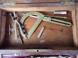 a wooden box with various tools inside of it