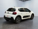 the rear of a white citrole parked in a garage