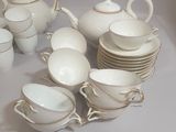 a lot of cups and saucers sitting on a table