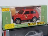 a red toy car in a box on top of a table