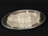 a silver tray with a candle on it on a black background