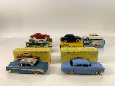 four toy cars are lined up in a row on a table