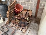 a pile of wood sitting on a pallet next to a bucket
