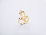 a close up of a gold ring with a yellow stone