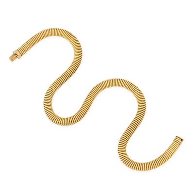 a gold snake bracelet on a white background