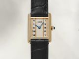 an image of a watch with a gold case and black leather strap