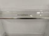 a close up of a stainless steel shelf with a sign on it