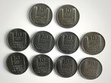 six different coins are arranged in a circle on a white surface