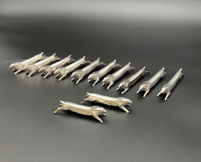 a close up of a bunch of silver animal figurines on a table