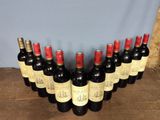 several bottles of wine are lined up on a wooden table