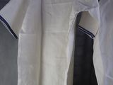 two white and blue shirts hanging on a clothes hanger