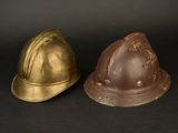 two helmets sitting next to each other on a black surface