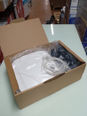 a box with a white shirt inside of it on a table