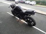 a black motorcycle parked on the side of the road