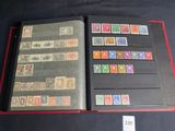an open book with stamps on it sitting on a table