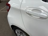 a white car parked in a parking lot next to other cars