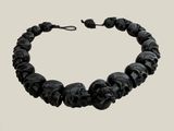 a close up of a bracelet with skulls on it