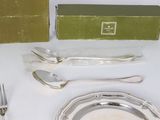 a silver plate with a fork, spoon and knife on it