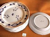 two plates and a bowl sitting on a table