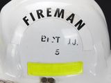a white fireman helmet with a yellow tag on it