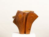 a wooden sculpture of an elephant on a white pedestal