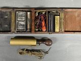 a small wooden box with a telephone inside of it