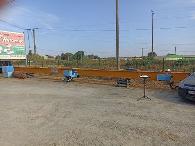 a car that is parked in a lot next to a fence