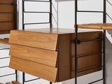 a wall of shelves that have wooden shelves on them