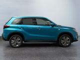the blue suv is parked in a room with a white wall