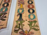 two wooden rulers with designs on them sitting on a table