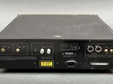 a close up of a black electronic device on a gray surface