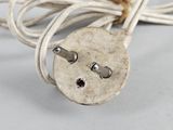 a close up of a white electrical plug on a table
