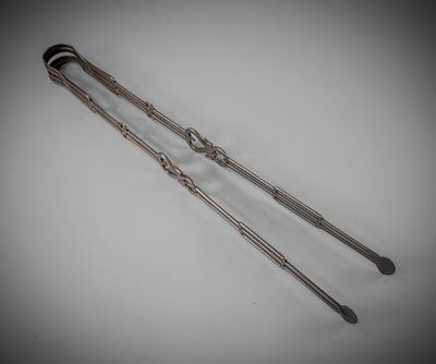 a pair of silverware spoons with handles on a white surface