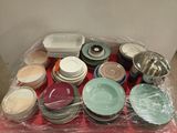 many plates and bowls on a red tray wrapped in plastic